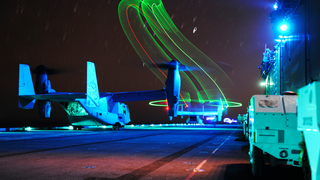 An MV-22 Osprey Fills The Night Sky Over The USS Boxer With Psychedelic Slinkies